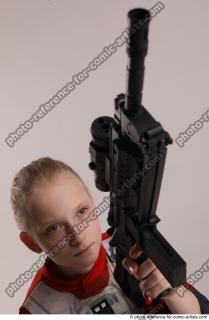 DENISA KNEELING POSE WITH GUN